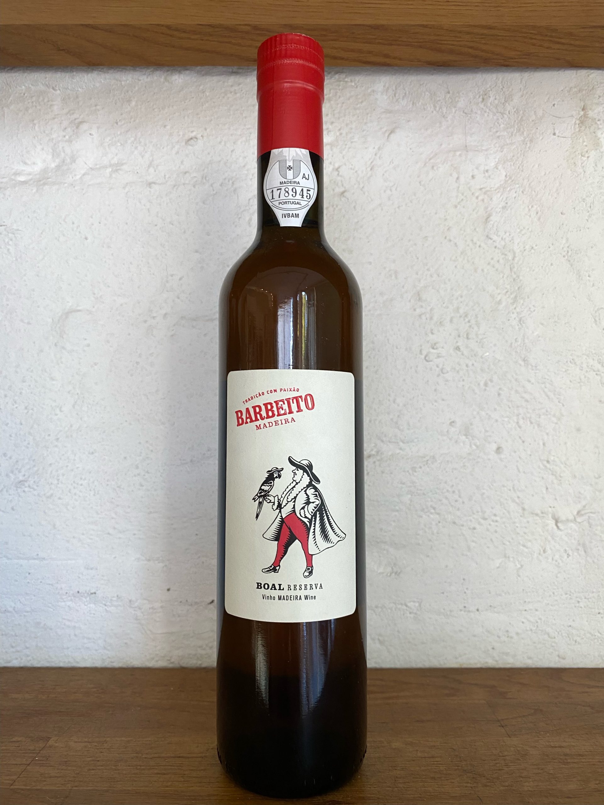 Rainwater Reserva Madeira Barbeito featuring a label with a man in red trousers and a parrot on his hand